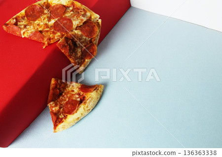 Pizza falling off the red pedestal 136363338