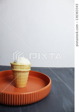 White Creamy Ice Cream in Waffle Cup on Plate on Gray Background 136363343