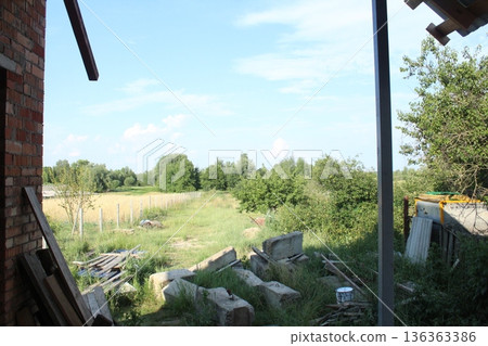 Construction beams on the ground.. Building Material Residues: Bricks, Concrete Beams on the Grass Construction beams on the ground.. Building Material Residues: Bricks, Concrete Beams on the Grass 136363386