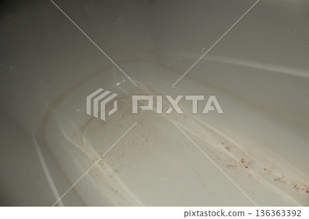 Dirt in the bathtub. Dirty strips of dirt rusty sand after taking a shower bath. Bath before cleaning Dirt in the bathtub. Dirty strips of dirt rusty sand after taking a shower bath. Bath before cleaning 136363392