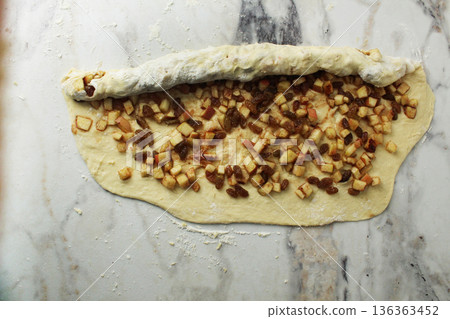 Wraps a layer of yeast dough in a roll. Space for copyspace text 136363452