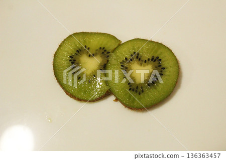 Kiwi in a heart-shaped cut on a white background, top view Kiwi in a heart-shaped cut on a white background, top view 136363457