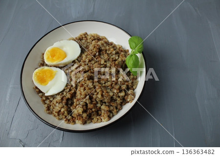 buckwheat boiled chicken egg greens on a gray background with space for text copyspace 136363482