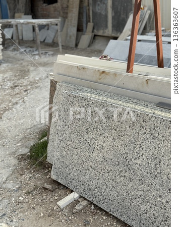 Granite slabs stacked outdoors in a construction area showing building materials Granite slabs stacked outdoors in a construction area showing building materials 136363607