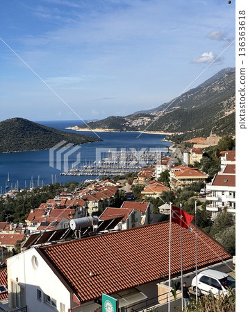 Scenic view of marina in coastal town with yachts and red rooftops, suitable for travel background Scenic view of marina in coastal town with yachts and red rooftops, suitable for travel background 136363618