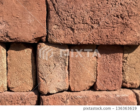 Brown brick wall texture with rough surfaces, perfect for architectural background use Brown brick wall texture with rough surfaces, perfect for architectural background use 136363619