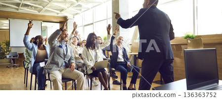 People colleagues raising hands to ask questions during business meeting in office. 136363752