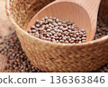 Brown lentils inside woven bowl with wooden scoop. Traditional pantry staple for wholesome meals. 136363846