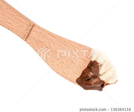 Dark and white chocolate spread on wooden spatula 136364116