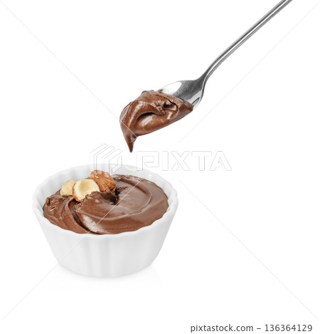 Chocolate hazelnut spread in bowl with spoon 136364129