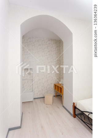 Bright bedroom alcove with arched doorway 136364239