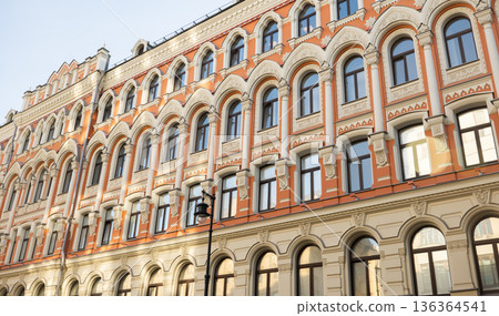 Ornate historic building facade with arched windows in Saint Petersburg 136364541