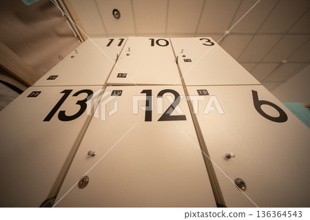 White lockers with numbers providing storage and organization in a public space 136364543