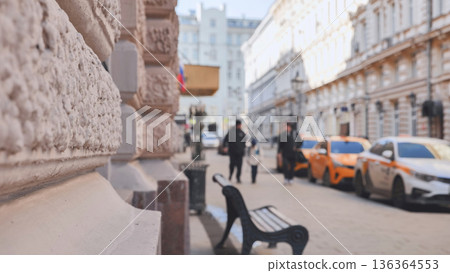 City street view showing urban architecture, people walking, and parked taxis City street view showing urban architecture, people walking, and parked taxis 136364553