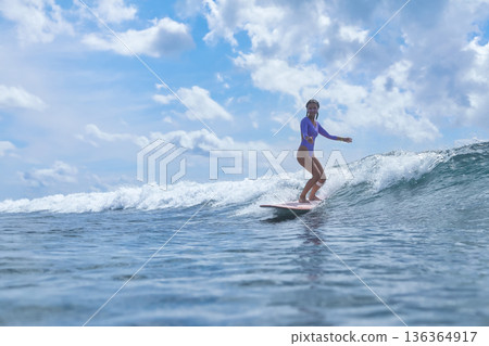 Girl Enjoys Longboard At Coast, Youthful Lady Rides Longboard Near Sunny Waves Girl Enjoys Longboard At Coast, Youthful Lady Rides Longboard Near Sunny Waves 136364917
