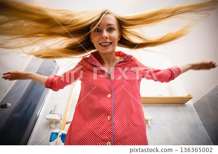 Woman showing her long blonde hair Woman showing her long blonde hair 136365002