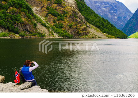 Tourist with camera on fjord, Norway Tourist with camera on fjord, Norway 136365206