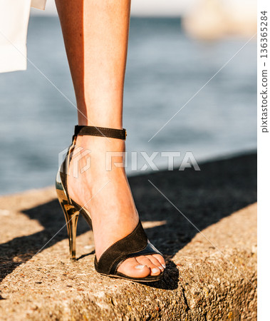 Woman feet in high heels summer shoes. Woman feet in high heels summer shoes. 136365284