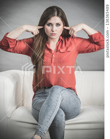 Woman being annoyed with noise Woman being annoyed with noise 136365489