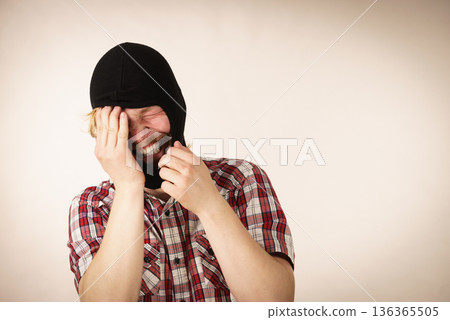 Sad man wearing balaclava Sad man wearing balaclava 136365505