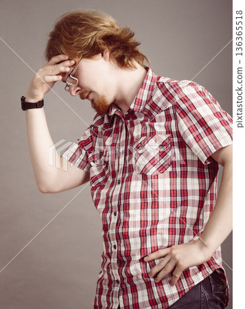 Man gesturing with hand touching his head Man gesturing with hand touching his head 136365518