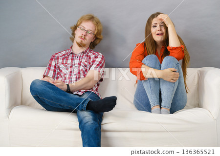 Woman and man after argue on sofa Woman and man after argue on sofa 136365521