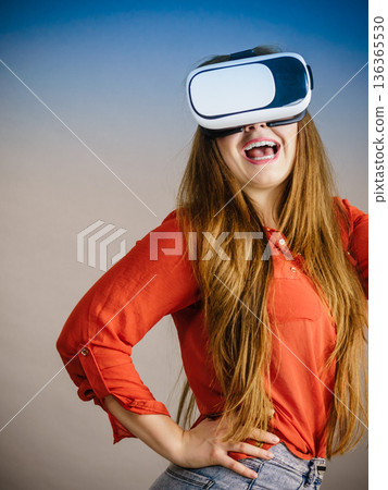 Girl wearing virtual reality goggles. 136365530
