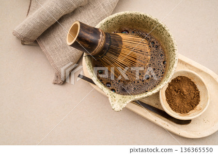 Preparing matcha tea with bamboo whisk and powder Preparing matcha tea with bamboo whisk and powder 136365550