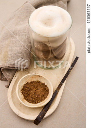 Latte coffee foam with cocoa powder on tray 136365567