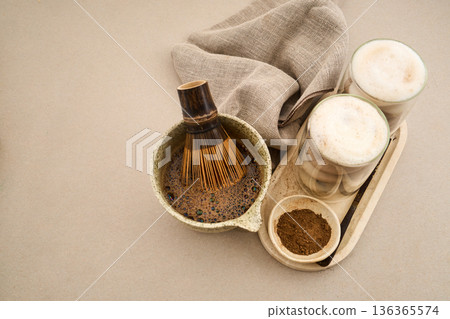 Preparing hojicha latte with whisk and roasted green tea Preparing hojicha latte with whisk and roasted green tea 136365574