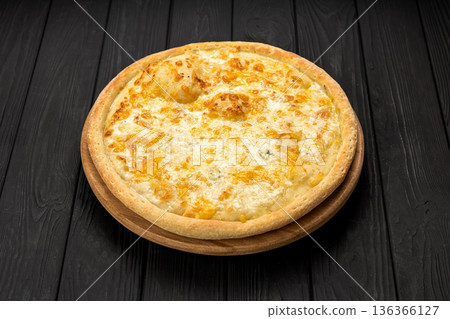 Quattro formaggi cheese pizza on wooden board, dark rustic background Quattro formaggi cheese pizza on wooden board, dark rustic background 136366127