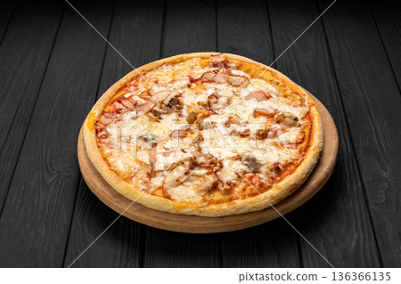 Cheesy chicken and mushroom pizza on wooden board, dark background Cheesy chicken and mushroom pizza on wooden board, dark background 136366135