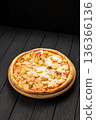 Chicken pineapple pizza with melted mozzarella on wooden board, dark background 136366136