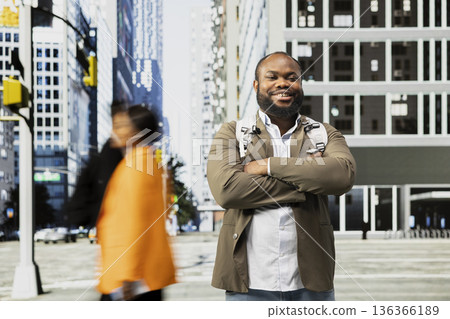 African american impatient businessman waiting to cross the street, busy everyday life of multicultural pedestrians crowd. Diverse people on their morning commute on downtown avenue. 136366189