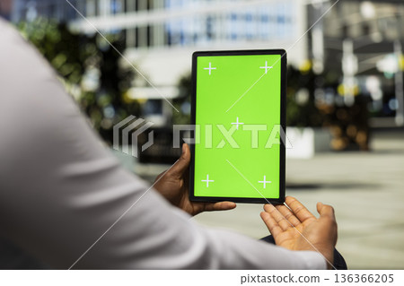Vertical mockup screen on tablet with black man sitting on a park bench, admiring skyscrapers and metropolitan area vibe. Confident posture and modern street style for sidewalk scenery. Vertical mockup screen on tablet with black man sitting on a park bench, admiring skyscrapers and metropolitan area vibe. Confident posture and modern street style for sidewalk scenery. 136366205