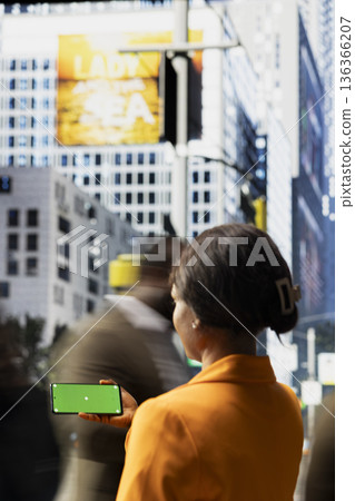 Horizontal isolated screen on smartphone near city crowd of different ages crossing together reflects multicultural motion, daily commute activity and flow of modern street life. Horizontal isolated screen on smartphone near city crowd of different ages crossing together reflects multicultural motion, daily commute activity and flow of modern street life. 136366207