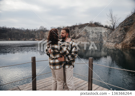 Couple shares a special moment at the lake on a cloudy day during Valentines Day celebration Couple shares a special moment at the lake on a cloudy day during Valentines Day celebration 136366264
