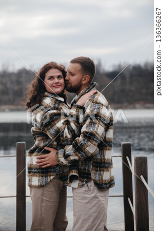 Couple enjoys romantic moment by a lake during winter season while celebrating their love on Valentines Day Couple enjoys romantic moment by a lake during winter season while celebrating their love on Valentines Day 136366267