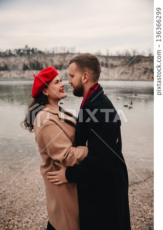 Couple enjoys a moment of love by the lake on Valentine Day in winter 136366299