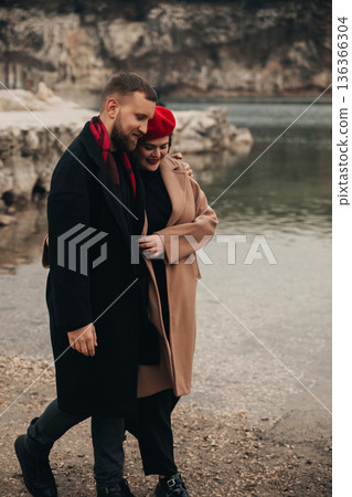 Couple walks by the water on Valentines Day sharing a moment of love and connection in a scenic setting 136366304