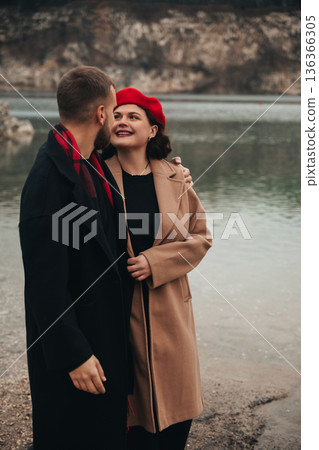 Couple shares a moment by the water on Valentines Day while enjoying their romance and connection in a natural setting 136366305