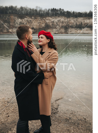 Couple enjoying a romantic moment by the water on Valentines Day in a scenic outdoor location 136366306