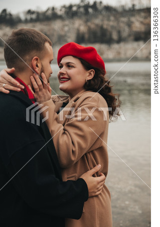 Couple enjoys a romantic moment by the water on Valentines Day in winter 136366308