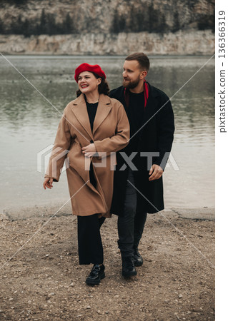 Couple walks by the water on a cold day enjoying each others company for Valentines Day Couple walks by the water on a cold day enjoying each others company for Valentines Day 136366319