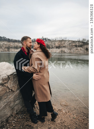 Couple enjoying time together by the water on Valentines Day in winter Couple enjoying time together by the water on Valentines Day in winter 136366328