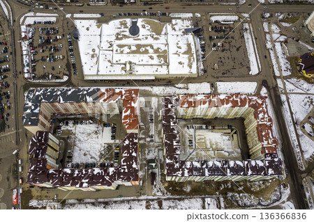 Top view of winter city landscape with tall buildings. Drone aerial photography. Top view of winter city landscape with tall buildings. Drone aerial photography. 136366836