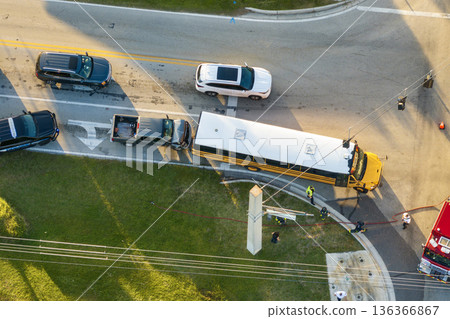 School bus and pick-up truck car crash with first responders helping at accident site on American street. Vehicle collision on road in USA School bus and pick-up truck car crash with first responders helping at accident site on American street. Vehicle collision on road in USA 136366867