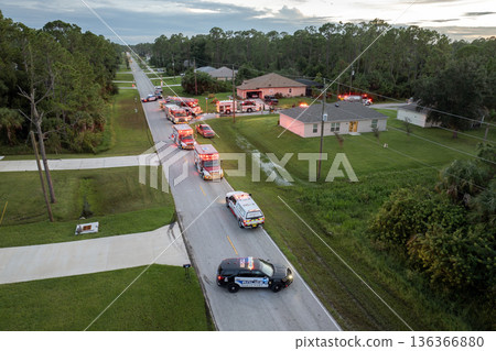 Firefighter trucks at fire alarm scene of suburban house. First responders at potential fire hazard at Florida home Firefighter trucks at fire alarm scene of suburban house. First responders at potential fire hazard at Florida home 136366880