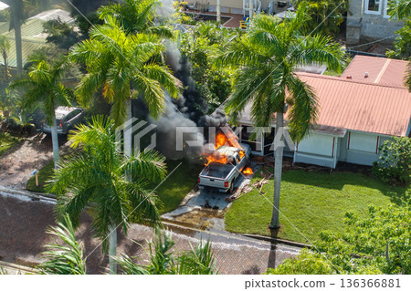 Firefighters extinguishing car fire in Florida after hurricane flooding caused electrical short circuit Firefighters extinguishing car fire in Florida after hurricane flooding caused electrical short circuit 136366881