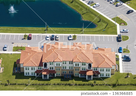 Apartment-style condominiums in Florida suburbs, surrounded by greenery and designed for modern suburban living in the USA 136366885